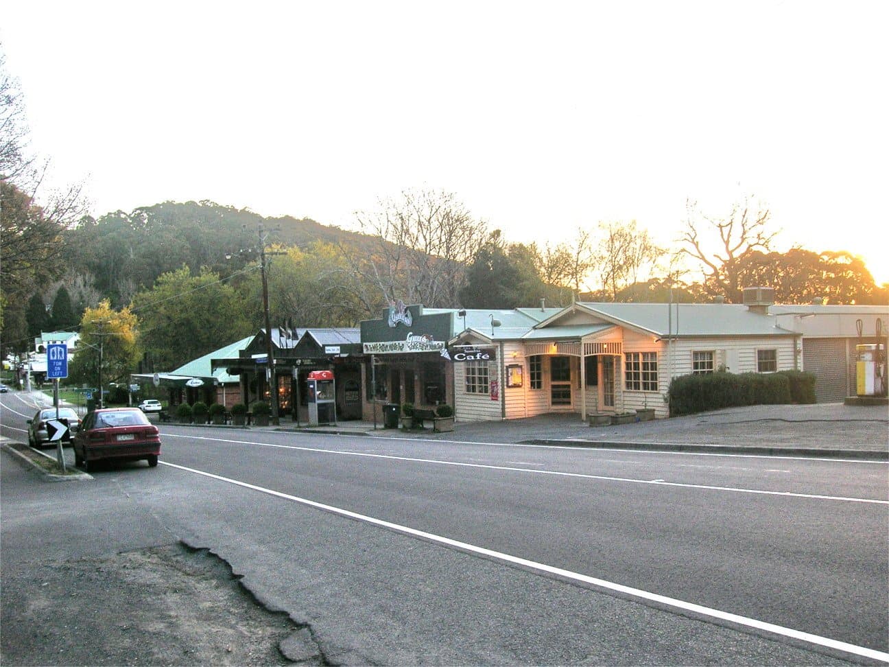 The main road through Sassafras, with a row of low shopfronts and hills behind