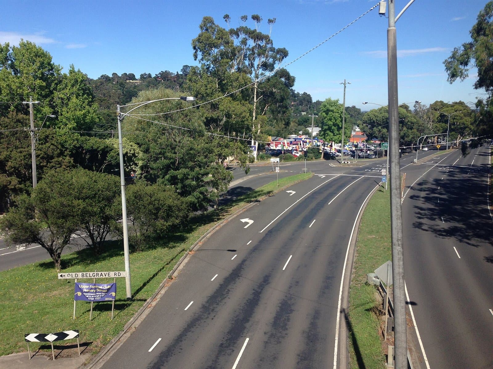 The divided Burwood Highway curving uphill between trees